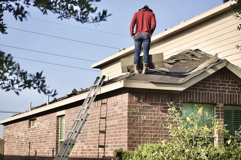 Professional roofer working on a residential roof in Adams Crossing